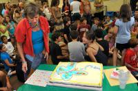 Mrs. Goldstein admires the cake